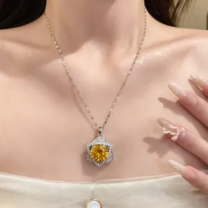 Detailed macro view of a silver necklace featuring a yellow round stone star pendant.