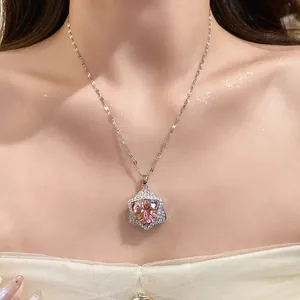 Close-up view of a luxury star-shaped champagne pendant necklace on a female model.
