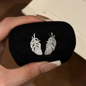 Exquisite silver feather stud earrings with sparkling pavé cubic zirconia detail