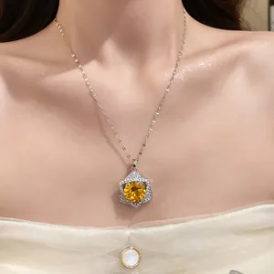 Close-up detail of luxury star pendant necklace with yellow zircon on a model
