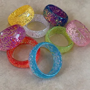 Set of colorful dopamine style resin bangles with translucent sparkling glitter finish