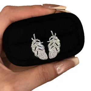 Elegant silver feather stud earrings featuring sparkling cubic zirconia pavé accents
