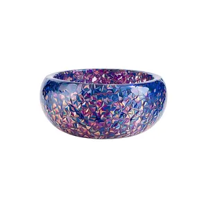 Colorful resin bangle with geometric faceted texture in vibrant dopamine style