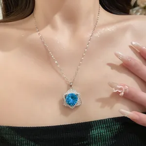 Detailed shot of light luxury star pendant necklace with a blue gemstone