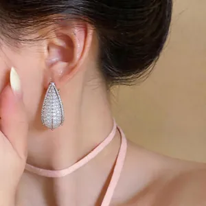 Elegant copper drop earrings with teardrop crystal inlay shown on an Asian model