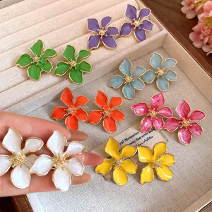 Close-up of vibrant enamel flower earrings in various colors for sweet summer style