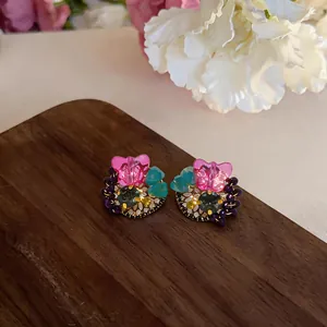 Detailed view of colorful butterfly crystal stud earrings with vibrant beads