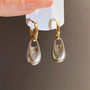 Vintage crinkled teardrop pendant hoop earrings with gold and silver metallic texture