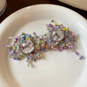 Unique irregular stud earrings featuring colorful sequin clusters and silver spheres