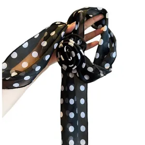 Vintage black and white polka dot chiffon scarf necklace with a delicate flower detail.