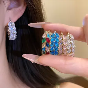 Close-up detail of colorful zircon wheat ear hoop earrings shown in a variety of styles