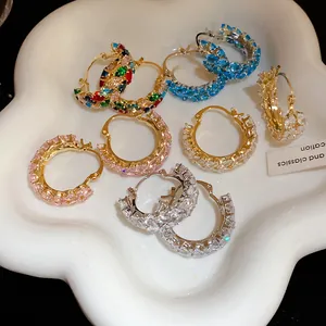 Detailed macro shot of vintage zircon wheat-ear hoop earrings in vibrant colors