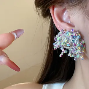 Detailed close-up showing the intricate colorful sequins and glass beads on the irregular earrings