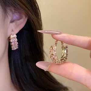 Detail view of vintage gold hoop earrings with pink marquise zircon wheat ear pattern