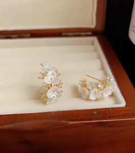 Detailopname van elegante bloemoorbellen met witte bloemblaadjes in een houten doosje