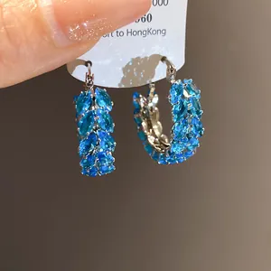 Close-up of vintage blue zircon wheat ear hoop earrings with a sparkling finish