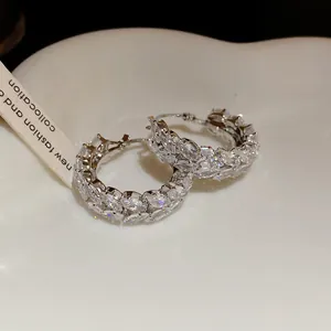 Detailed macro shot of vintage zircon wheat ear hoop earrings with a sparkling silver finish