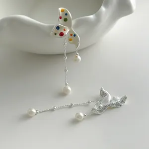 Detail of sweet colorful polka dot flower tassel earrings with pearls and silver finish
