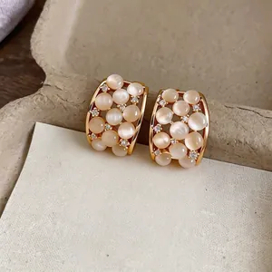 Elegant 18k gold plated earrings featuring moonstone cat's eye gems and zircons.
