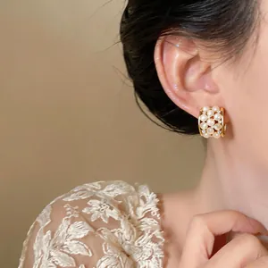 Close-up view of elegant 18k gold plated hoop earrings with cat eye stones and zircons