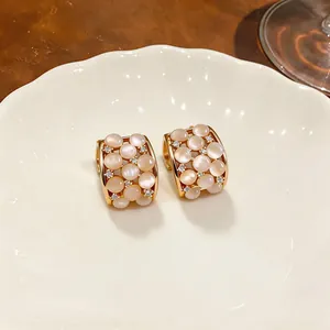Close-up of elegant 18k gold plated cat's eye stone earrings with zircon