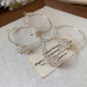 Elegant silver hoop earrings with zircon-encrusted hollow butterfly charms