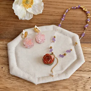 Detailed view of handmade beaded necklace with preserved rose pendant and butterfly earrings.