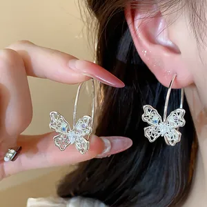Exquisite hollow butterfly hoop earrings with colorful zircons worn on ear for women