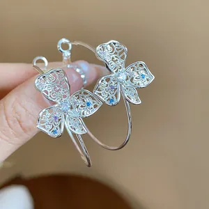 Detailed view of silver hoop earrings featuring hollow flower and colorful zircon stones