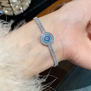 Macro view of an elegant silver evil eye bracelet with sparkling zircons on a wrist