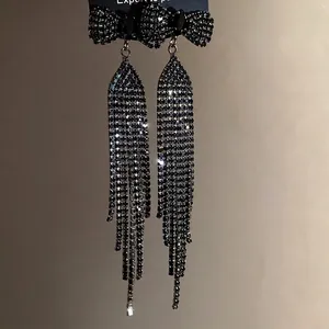 Elegant black rhinestone bow tassel drop earrings for women with silver pins.