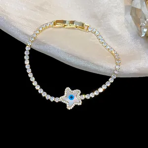 Close-up detail of 18k gold plated star bracelet featuring pavé zircons and evil eye charm