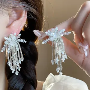 Detailed view of elegant glass flower tassel earrings with sparkling beads