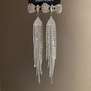 Elegant silver bowknot earrings featuring long shimmering rhinestone tassels detail