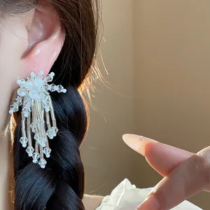 Detailed close-up showing elegant handmade glass bead flower tassel earrings on a model