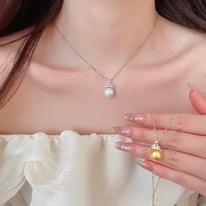Elegant necklace set featuring round pearls with crown-shaped zircon toppers on a model