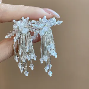 Detailed close-up of sweet glass flower tassel earrings with sparkling clear beads.
