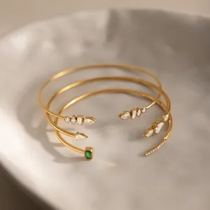 Detailed close-up of 18k gold plated stainless steel bangles with sparkling zirconia stones.