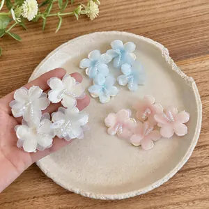 Detailed close-up of colorful chiffon flower earrings with delicate glass beads