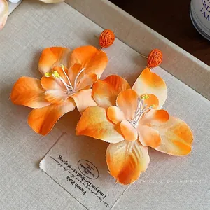 Bohemian large orange fabric flower stud earrings with raffia accents for vacation