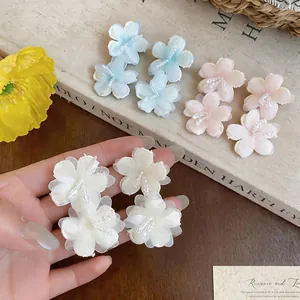 Close-up view of elegant chiffon flower stud earrings with delicate glass bead centers