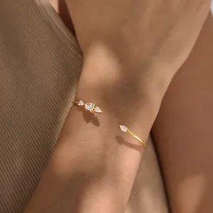 Detail view of 18k gold plated stainless steel cuff bracelet with pear-cut zircons