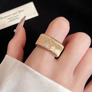 Exquisite gold-tone woven textured open ring for women worn on an index finger