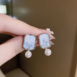 Detail showing crushed ice texture and pearl dangle of Korean style zircon earrings