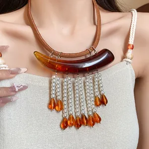 Dettaglio della collana vintage Maillard in acrilico ambrato con nappe di perle