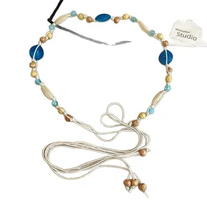 Elegant Bohemian style beaded waist chain featuring blue gemstones and natural wood beads