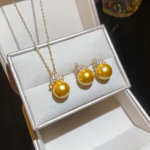 Detailed view of elegant golden pearl jewelry set featuring round zircon accents in a box