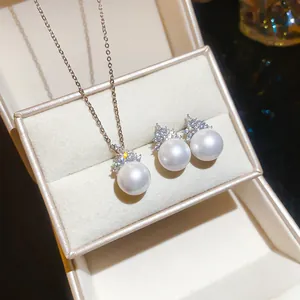 Elegant jewelry set featuring round white pearls and sparkling zircons in a gift box.