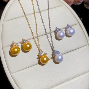 Detailed close-up of elegant gold and silver pearl jewelry sets on a display tray.