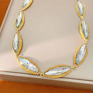 Detailed close-up of vintage marquise-cut crystal necklace with gold beaded border design